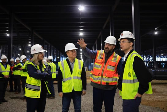 U.S. Secretary of Transportation Pete Buttigieg, far right, listens to a worker’s explanation on Friday as he visits the site of the BlueOval SK Battery Park Kentucky with vice president of the Ford EV Industrialization Lisa Drake, far left, and CEO Robert Jonghan Rhee of BlueOval SK, second from left. [U.S. DEPARTMENT OF TRANSPORTATION]