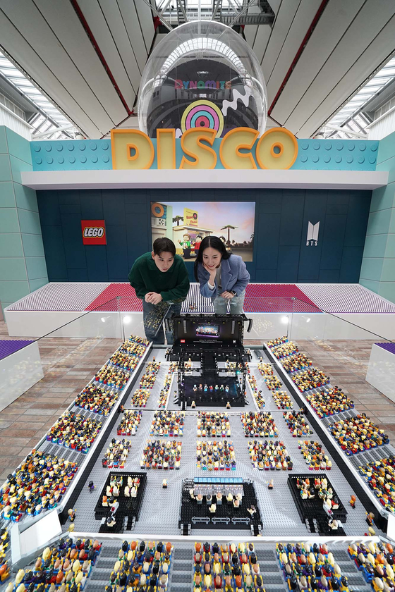 Customers look around a Lego pop-up store which recreated BTS' global mega-hit song "Dynamite" at The Hyundai Seoul in western Seoul on Tuesday. [YONHAP]