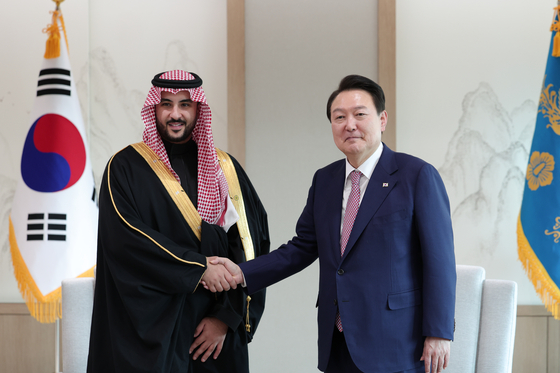 President Yoon Suk Yeol, right, poses with Saudi Defense Minister Khalid bin Salman in Seoul on Tuesday. [PRESIDENTIAL OFFICE]