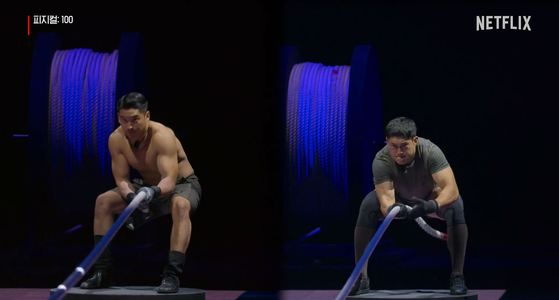 Contestants Woo Jin-yong and Jung Hae-min face off each other in a rope-pulling contest in the last episode of ″Physical:100″ [NETFLIX]