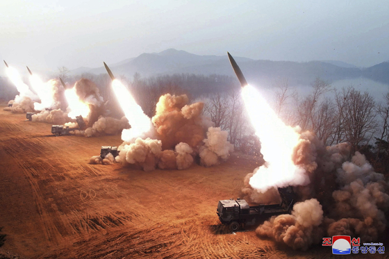 North Korea conducts an artillery drill, apparently testing tactical guided missiles Thursday, in a photo released by the state-run Korean Central News Agency Friday. [YONHAP]