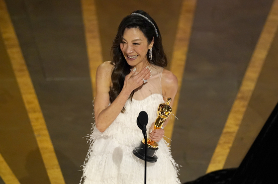 Michelle Yeoh accepts the award for best performance by an actress in a leading role for ″Everything Everywhere All at Once″ at the Oscars ceremony held at the Dolby Theatre in Los Angeles Sunday local time. [AP]