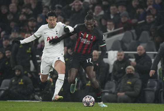 Tottenham's Son Heung-min, left, and AC Milan's Rafael Leao in action during a Champions League round of 16 second leg match at Tottenham Hotspur Stadium in London on Wednesday. [AP/YONHAP]