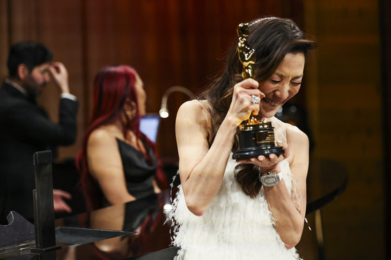 Best Actress Michelle Yeoh reacts after having her Oscar engraved at the Governors Ball following the Oscars show at the 95th Academy Awards in Hollywood, Los Angeles, California, U.S., Sunday local time. [REUTERS]