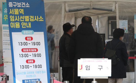 People wait in a queue at a Covid-19 testing center at Seoul Station on March 7. [NEWS1]