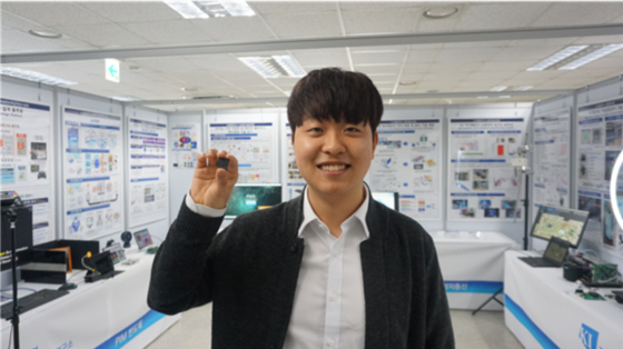 Kim Sang-jin, the lead author for the DynaPlasia processing-in-memory chip research project and a PhD student at KAIST, holds the DynaPlasia chip. [MINISTRY OF SCIENCE AND ICT]