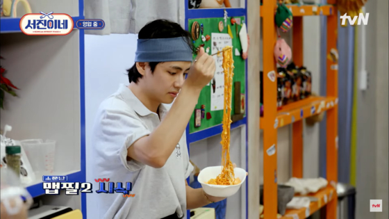 BTS V eating ramyeon in a scene of the ongoing travel-cooking reality show "Jinny's Kitchen" [SCREEN CAPTURE]