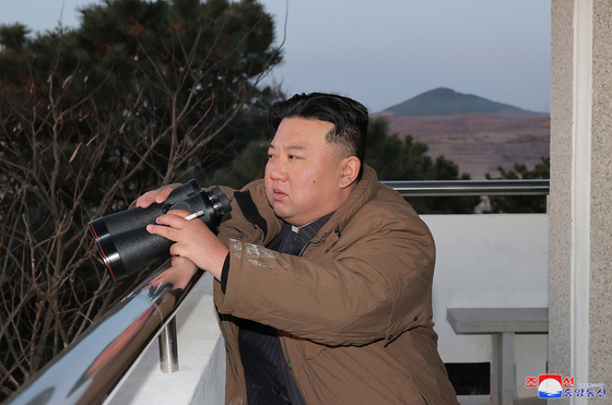 North Korea's Kim Jong-un watches as its military test-fires a Hwasong-17 intercontinental ballistic missile on Thursday, according to its state media Friday. [KOREAN CENTRAL NEWS AGENCY]