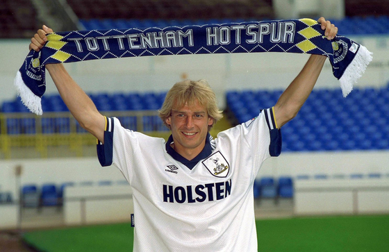 Jurgen Klinsmann holds up a Tottenham Hotspur scarf after signing with the club in 1994.  [TOTTENHAM HOTSPUR]