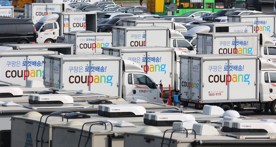 Delivery trucks of a major e-commerce platform Coupang is parked at a parking lot in Seoul on May 12, 2022. [YONHAP] 