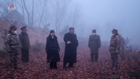 North Korean leader Kim Jong-un, center, is seen in footage released by Pyongyang's Korean Central Television alongside his daughter Kim Ju-ae overseeing drills simulating a nuclear counterattack that the North's state media said took place this past weekend. [YONHAP]