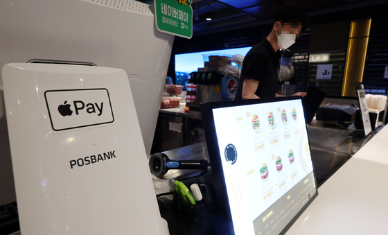 An Apple Pay sticker is shown on a counter at a diner in Seoul on Monday. [YONHAP]