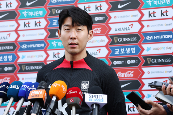 Son Heung-min speaks to reporters following his arrival at the Paju National Football Center in Paju, Gyeonggi on Tuesday. [YONHAP]