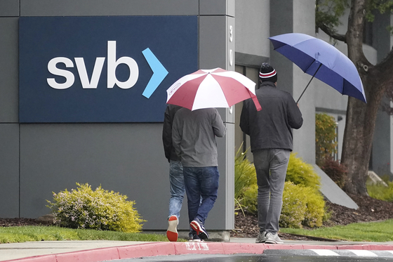 People walk past Silicon Valley Bank headquarters in California on March 10. [AP]
