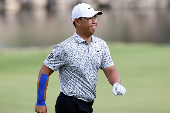 Tom Kim reacts after making par on the 11th green during day one of the World Golf Championships-Dell Technologies Match Play at Austin Country Club on Wednesday in Austin, Texas.  [GETTY IMAGES]
