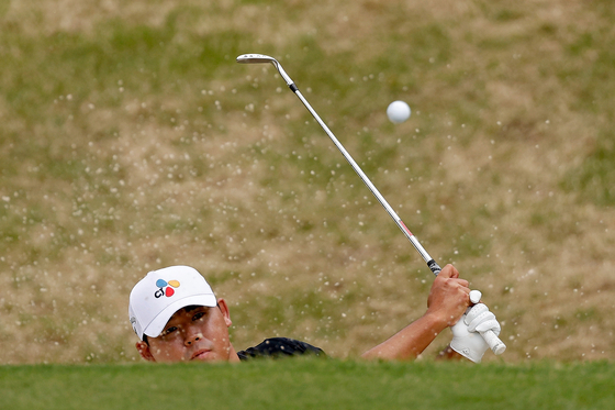 Kim Si-woo plays his shot from the bunker on the eighth green during day two of the World Golf Championships-Dell Technologies Match Play at Austin Country Club on Thursday in Austin, Texas. [GETTY IMAGES]