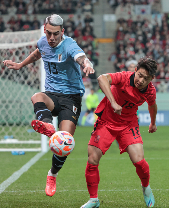 Lee Kang-in, right, in action during a friendly with Uruguay at Seoul World Cup Stadium in Mapo District, western Seoul on Tuesday. [YONHAP] 