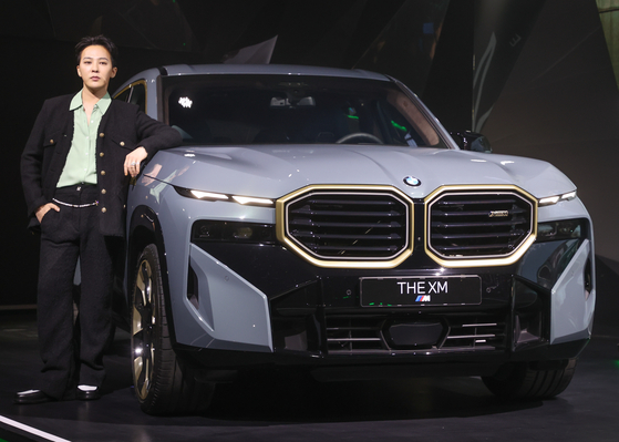 Singer G-Dragon poses with the BMW XM during an unveiling event Tuesday in southern Seoul. [YONHAP] 