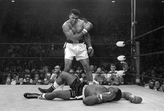 In this May 25, 1965, file photo, Muhammad Ali stands over Sonny Liston after knocking Liston down during their heavyweight championship bout in Lewiston, Maine.  [AP/YONHAP]