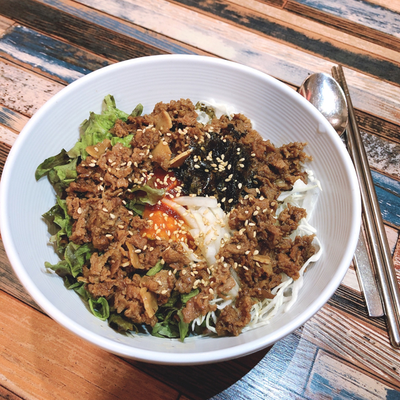 Jeyuk bibimbap, or rice mixed with vegetables and seasoned pork belly, sold at Karly & Merry Kitchen [KARLY & MERRY KITCHEN]