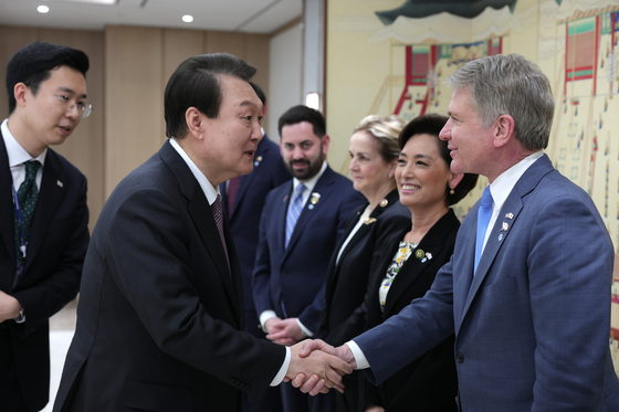 President Yoon Suk Yeol, left, greets Rep. Michael McCaul, who is leading a U.S. congressional delegation of the House Foreign Affairs Committee on a trip Korea, at the Yongsan presidential office in central Seoul Wednesday. [PRESIDENTIAL OFFICE]