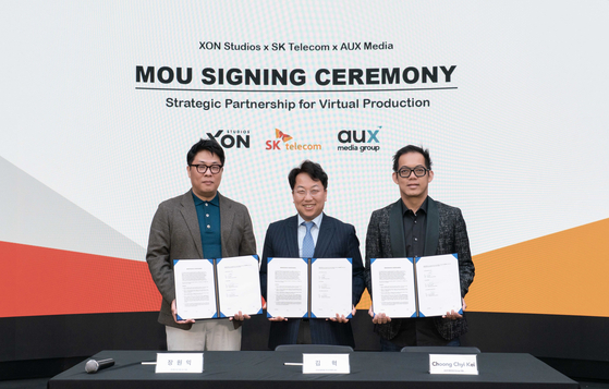 From left: Chang Won-ick, XON Studios CEO, Kim Hyuk, head of media partnership at SK Telecom, and Choong Chyi Kei, AUX Media CEO, during a signing ceremony for technological cooperation in virtual content production [SK TELECOM] 