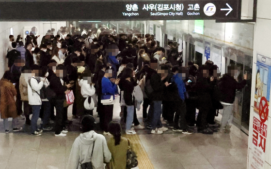 Riders wait for a subway train heading to Gimpo, Gyeonggi, at Gimpo International Airport Station in Gangseo District, western Seoul, on Thursday. [YONHAP]