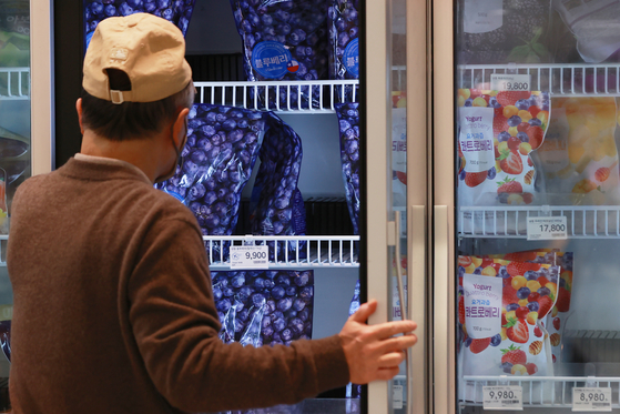 A customer shops for frozen blueberries at a discount store in Seoul on Sunday. [YONHAP]
