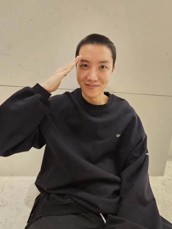 J-Hope poses for the camera after getting his hair shaved in preparation for military enlistment. [SCREEN CAPTURE]