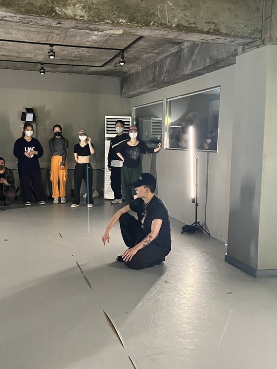 A teacher discussing the concept for his choreography to his students at a regular dance class. [SOFIA DEL FONSO]