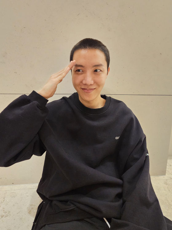 J-Hope poses for the camera after getting his hair shaved in preparation for military enlistment [SCREEN CAPTURE]
