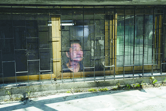 A scene in movie "Parasite" shows actor Song Kang-ho standing in a half-underground apartment, or a banjiha. [CJ ENM]