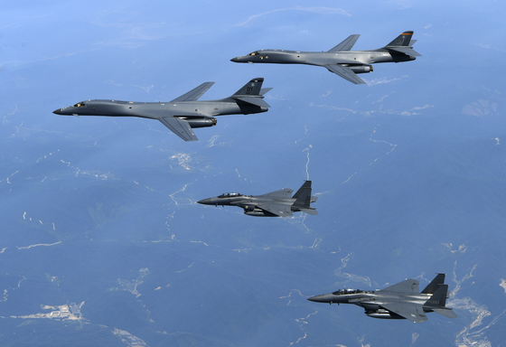 In light of North Korea's escalating military threats, South Korea and the United States agreed last year to increase the rotation of U.S. strategic assets deployed to the Korean Peninsula, such as the two B-1B supersonic bombers at the top of the formation in this photo. [REPUBLIC OF KOREA AIR FORCE]