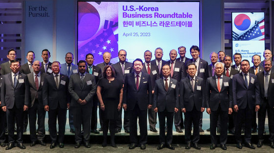 President Yoon Suk Yeol, center in the front row, poses for a photo, alongside with business leaders including Samsung Electronics Executive Chairman Lee Jae-yong, far left in the second row, Hyundai Motor Executive Chair Euisun Chung, third from left in the front row, SK Inc. Chairman Chey Tae-won, second from right in the front row, LG Corporation Chairman Koo Kwang-mo, second from left in the second row. [YONHAP]