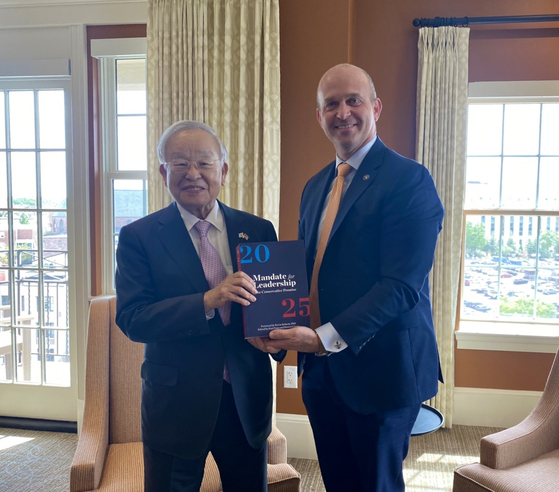 Korea Enterprises Federation Chairman Sohn Kyung-shik, left, poses with The Heritage Foundation President Kevin Roberts as they hold the foundation’s book “Mandate for Leadership: The Conservative Promise” at the office building in Washington on Tuesday. Sohn visited the foundation to discuss Korea’s labor environment and working hours. [KOREA ENTERPRISES FEDERATION]