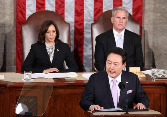 Korean President Yoon Suk Yeol, front, gives an address to a joint meeting of U.S. Congress as U.S. Vice President Kamala Harris, left, and House Speaker Kevin McCarthy, right, look on in the House chamber at Capitol Hill in Washington on Thursday. [JOINT PRESS CORPS]