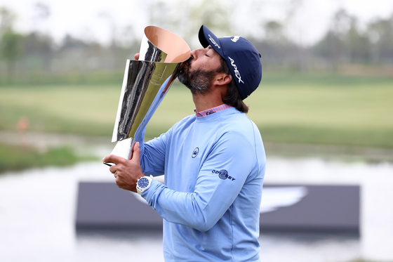 Pablo Larrazabal of Spain kisses the trophy after winning the Korea Championship Presented by Genesis at the Jack Nicklaus Golf Club Korea in Incheon on Sunday. [GETTY IMAGES]