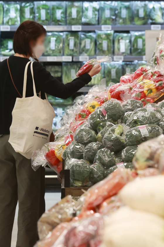 A person shops for groceries at a discount store in downtown Seoul on Tuesday. Inflation came in at 3.7 percent for the month of April, according to Statistics Korea. It was the first time inflation fell below 4 percent since February last year. [YONHAP]