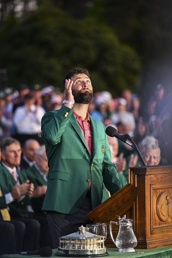 Jon Rahm of Spain thanks late Spanish golfer Seve Ballesteros while receiving the green jacket during a ceremony and trophy presentation following his four stroke victory in the final round of the 2023 Masters Tournament at Augusta National Golf Club on April 9 in Augusta, Georgia.  [GETTY IMAGES]