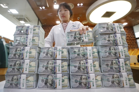 A bank official sorts dollar bills at Hana Bank's counterfeit response unit in central Seoul on April 26. [NEWS1]