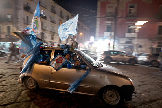 Fans celebrate on Thursday in Naples after Napoli won the Serie A title.  [AFP/YONHAP]