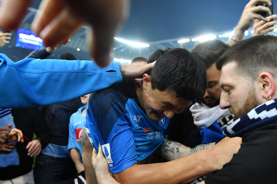 Napoli's Kim Min-jae is mobbed by fans on the pitch after the team secured their third Serie A title in Udine, Italy on Thursday.  [REUTERS/YONHAP]