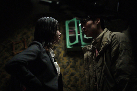 Jeon Jong-seo's character Park Joo-young, left, confronts Jin Seon-kyu's character No Hyung-Soo in "Bargain" (2022). [TVING]