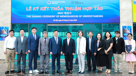 Officials from Inje University and Hanoi Polytechnic College pose for a photo after signing a memorandum of understanding on April 25. [INJE UNIVERSITY]