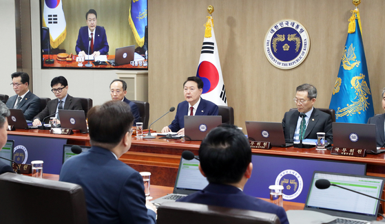 President Yoon Suk Yeol, center, speaks during a Cabinet meeting at the Yongsan presidential office in central Seoul Tuesday on the eve of his one-year anniversary in office. [JOINT PRESS CORPS] 