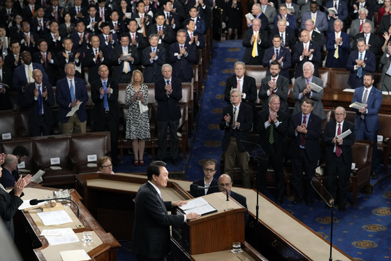 U.S. lawmakers give a standing ovation as Korean President Yoon Suk Yeol, on the podium, gives an address to a joint session of the U.S. Congress on Capitol Hill in Washington on April 27. [AP/YONHAP]