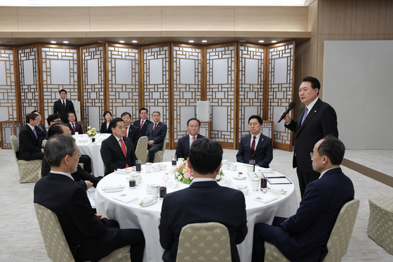 President Yoon Suk Yeol, right, speaks at a luncheon at the Yongsan presidential office in central Seoul with People Power Party leaders and presidential aides, asking for their cooperation in carrying out state affairs as he marks the one-year anniversary of taking office Wednesday. [PRESIDENTIAL OFFICE]