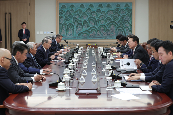 President Yoon Suk Yeol, center right, speaks at a meeting with a visiting Japanese business delegation at the Yongsan presidential office in central Seoul on Monday. [PRESIDENTIAL OFFICE]