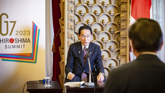 Japanese Prime Miniser Fumio Kishida answers question asked by JoongAng Holdings Chairman Hong Seok-hyun during a meeting at the prime minister’s residence in Tokyo on May 11. [JUN MIN-KYU]