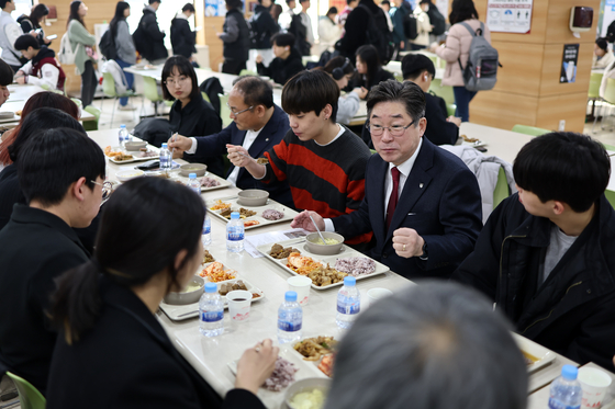 Kim eats breakfast with Korea University students at a school cafeteria on March 20 as part of the university’s so-called 1,000-won breakfast program, in which breakfast is served at just 1,000 won ($0.75) to help students beat inflation. [YONHAP]